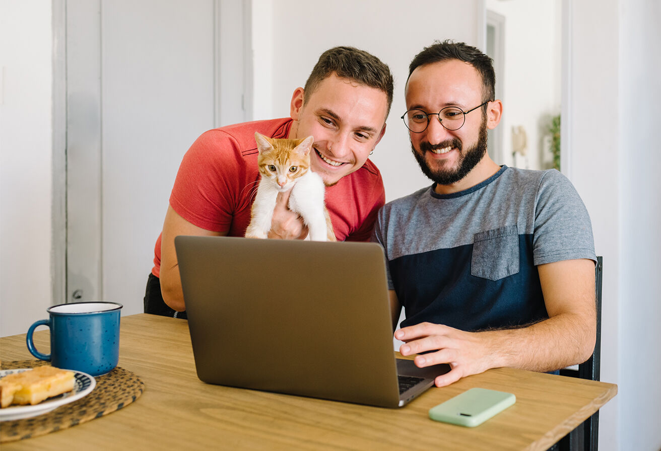 two men with cat shopping online